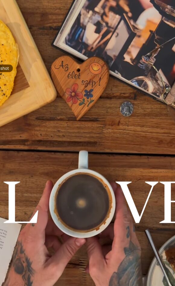 A Café Rev cup on a wooden table
